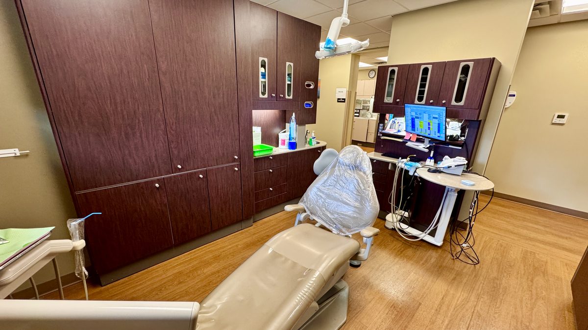 A dental chair in an empty operatory, ready for a patient who has not arrived