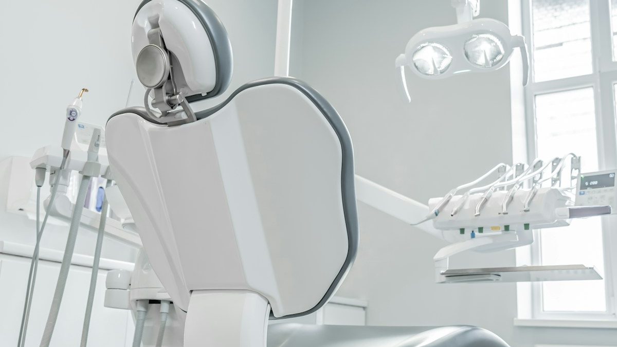 An empty dental operatory with the chair and equipment ready for the next patient