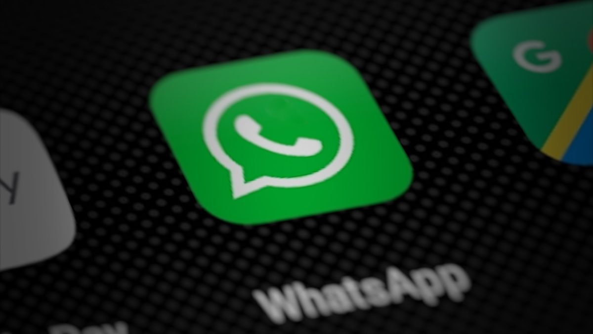 Close-up of a phone home screen with the green WhatsApp app icon in focus