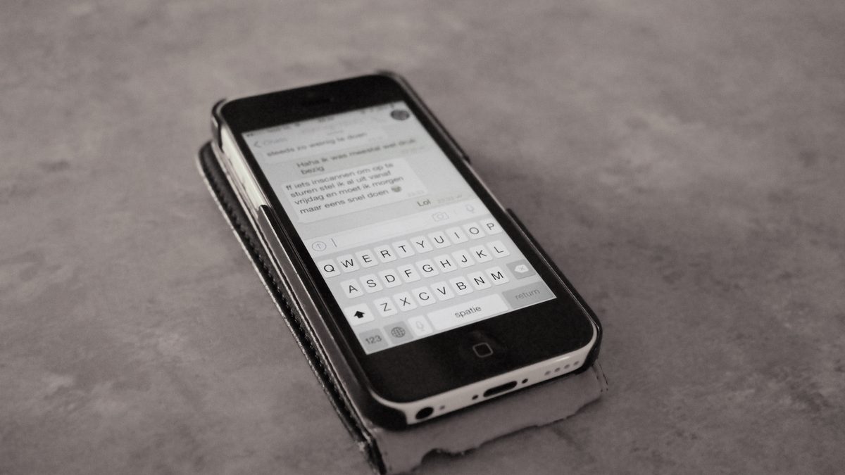 A person composing a message on a smartphone